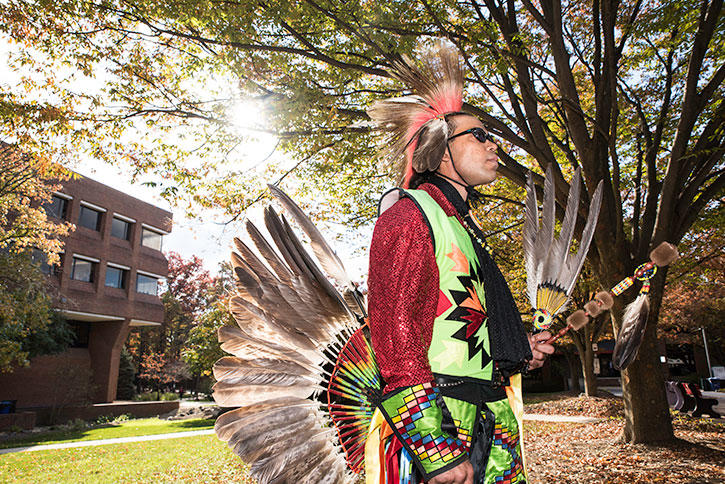 Native American in traditional dress on Mason Campus