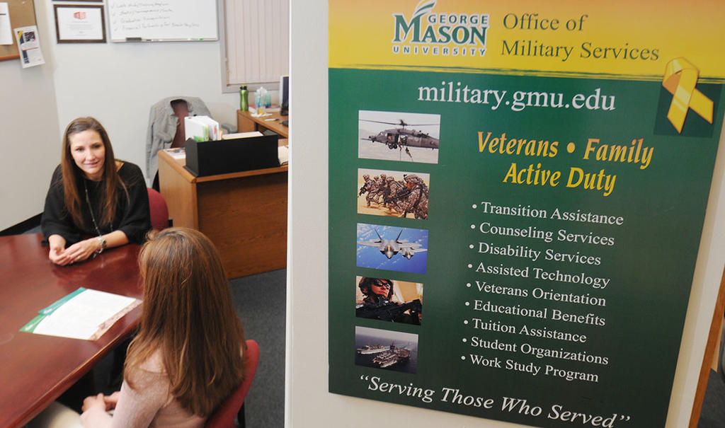 Mason military advisor speaks with student in office