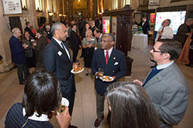 Mason alumni socialize at an event at the Smithsonian Castle